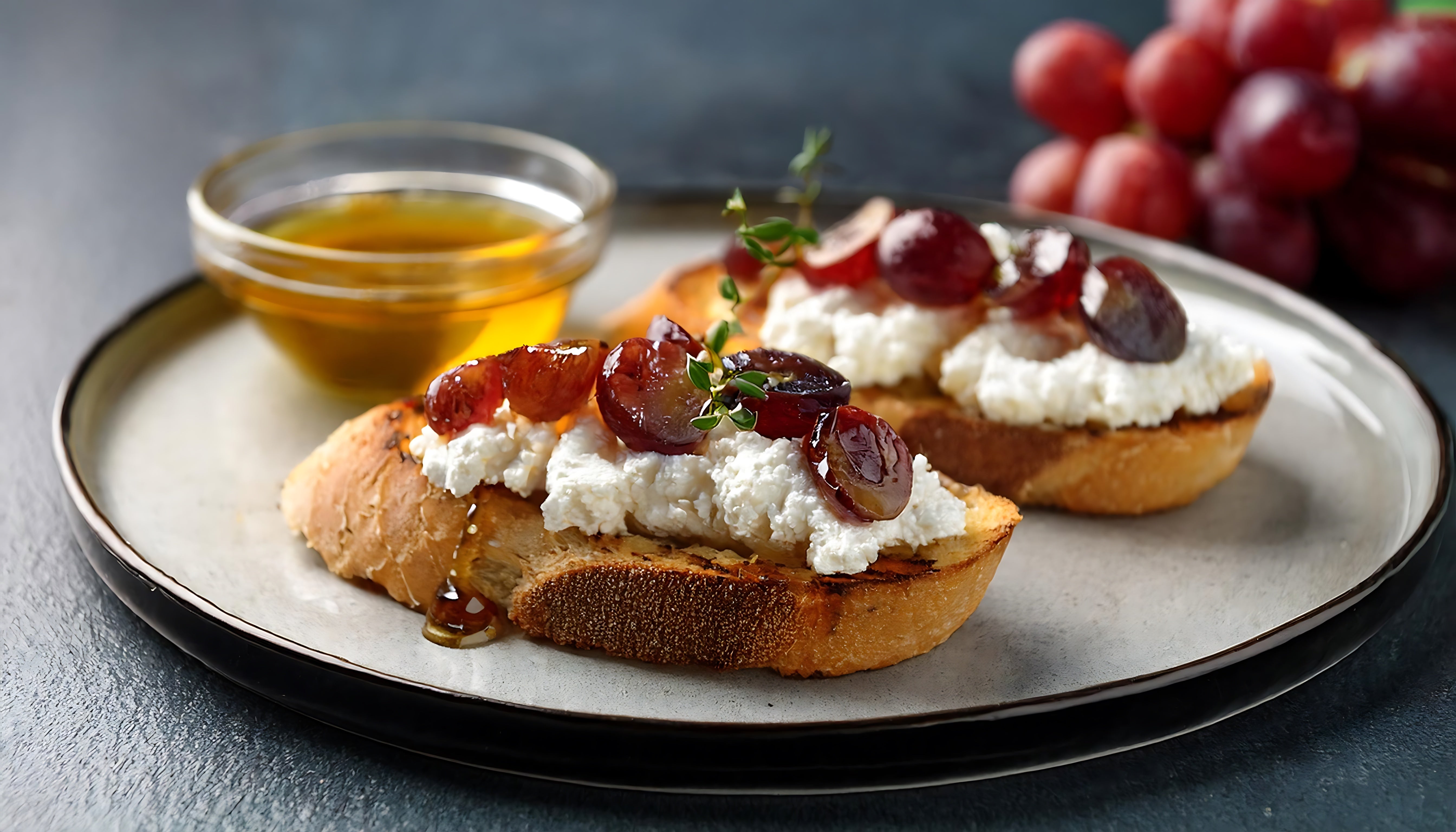Whipped Feta Cheese, Honey, argan oil and Roasted Grapes on Toasted Baguette Slices