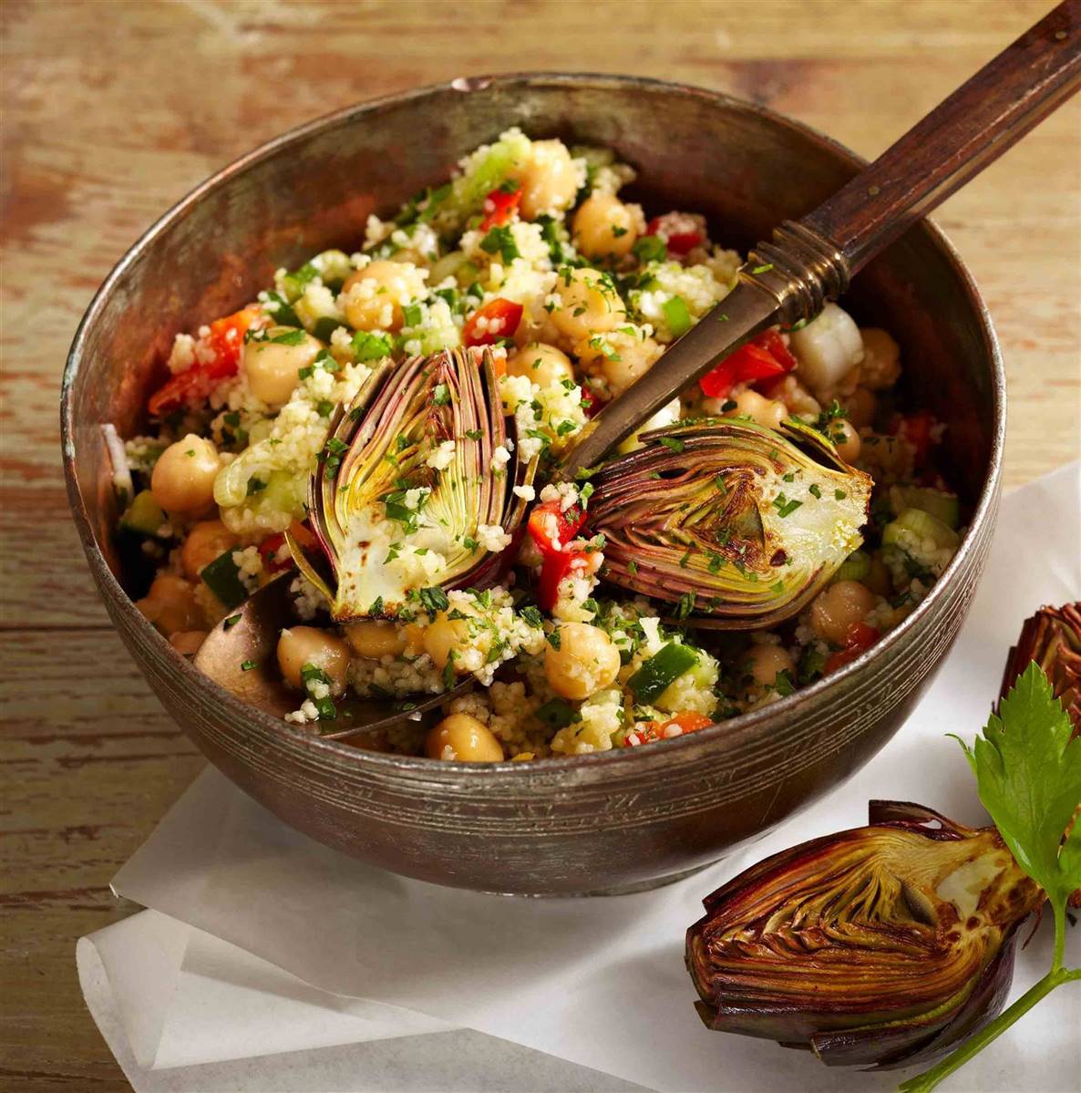 Couscous and chickpea salad with fresh vegetables and fried mini artichokes, finished with ARLO culinary argan oil for a Mediterranean-inspired dish