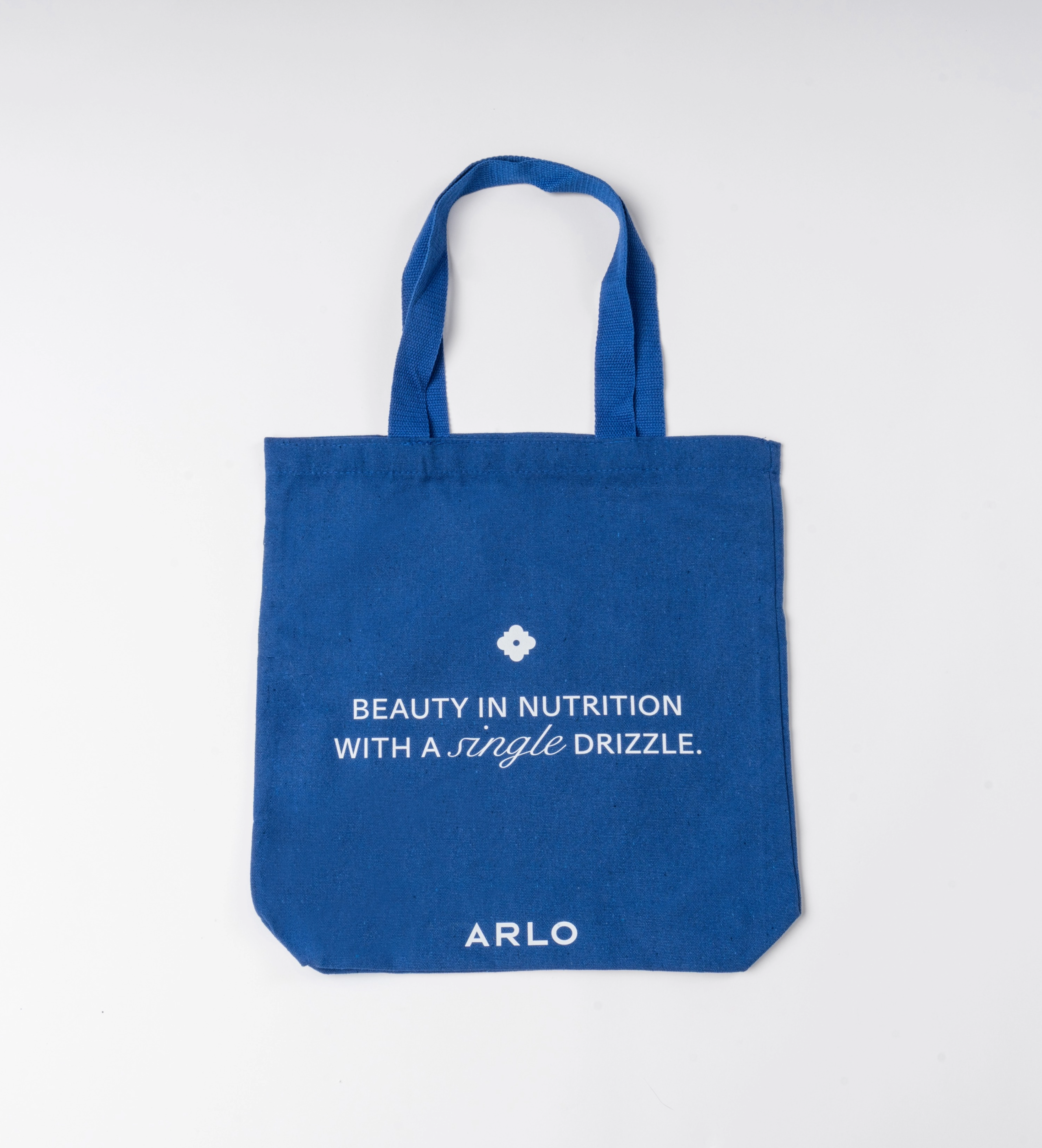 ARLO blue tote bag – Beauty in Nutrition with a single drizzle. Reusable cotton grocery bag, front with white branding