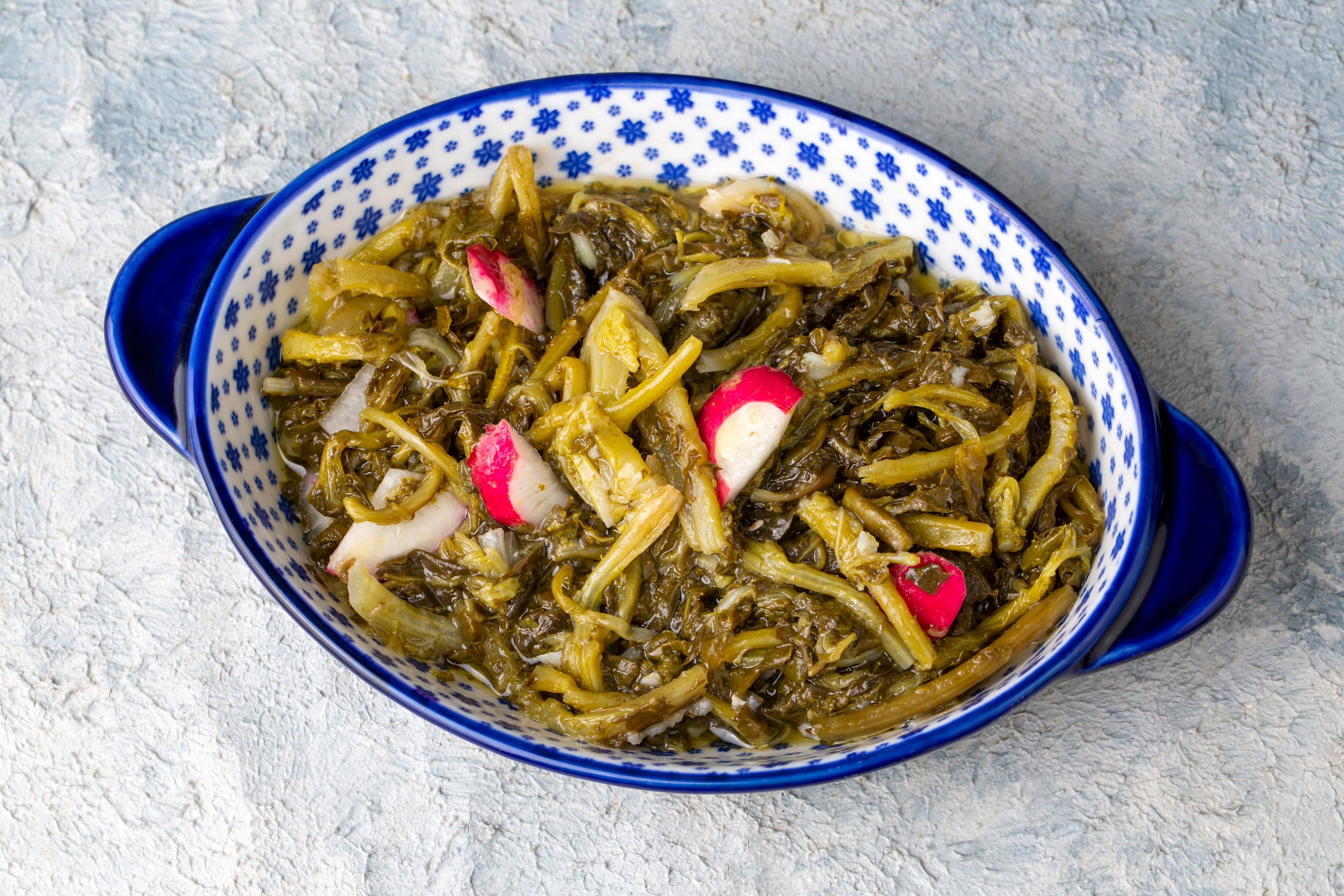 Radish and Aegean herb salad with sautéed onions and arugula, dressed in lemon and ARLO culinary argan oil for a Mediterranean twist