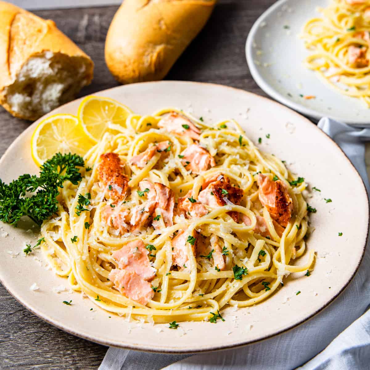 Pan-fried salmon over spaghetti with lemon-Parmesan cream sauce, finished with ARLO culinary argan oil for a rich Mediterranean flavor