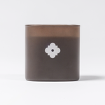 ARLO scented candle in brown glass – back view with white flower emblem, luxury home fragrance