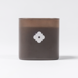 ARLO scented candle in brown glass – back view with white flower emblem, luxury home fragrance